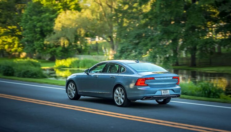 volvo s90 sedan exterior driving on a road